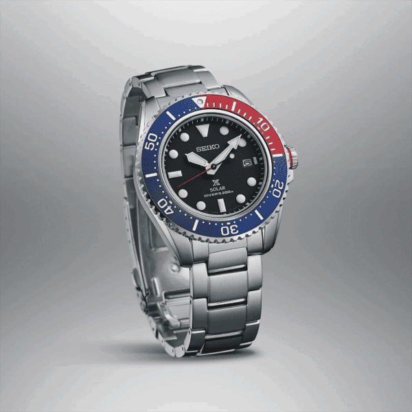 Luxury wristwatch with blue and red bezel and silver metal band.