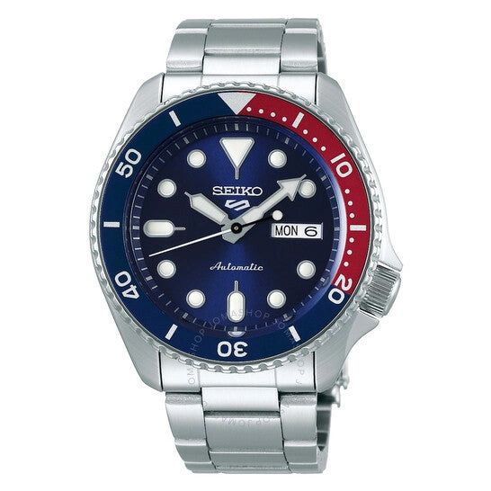 Seiko wristwatch with blue and red bezel on a silver metal band.