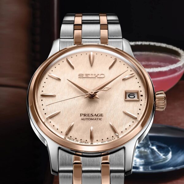 Elegant two-tone wristwatch with a rose gold dial and date display.
