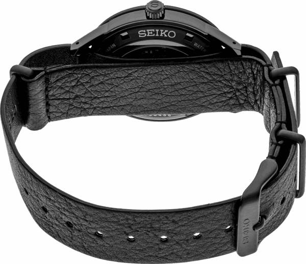 Close-up of a black Seiko wristwatch with a leather strap.