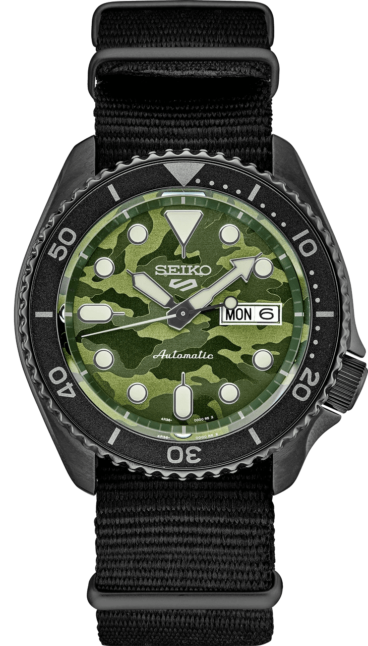 Seiko dive watch with green camouflage dial and black bezel.