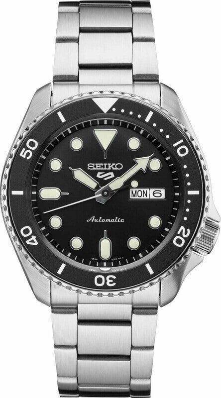 Seiko automatic dive watch with black dial and stainless steel bracelet.