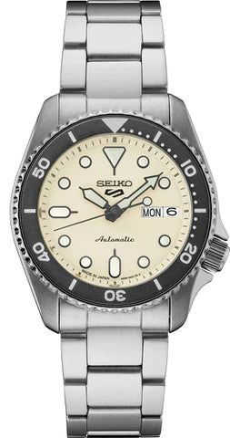 Seiko automatic wristwatch with a cream dial and stainless steel bracelet.