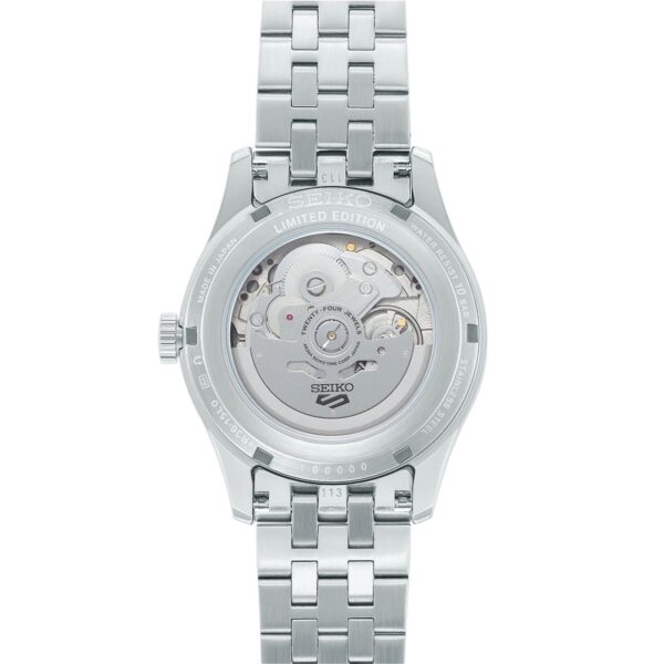 Back view of a silver wristwatch with visible mechanical movement.