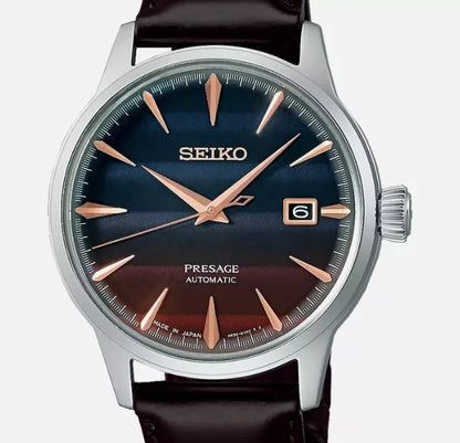 Seiko Presage automatic wristwatch with a dark blue sunburst dial and rose gold hands.