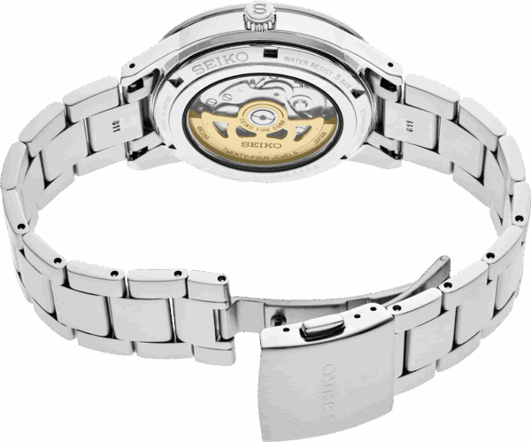 Back view of a luxury silver wristwatch with a transparent case showing its mechanical movement.