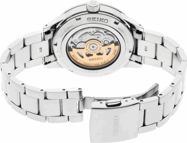 Close-up of Seiko automatic watch back with visible movement and metal bracelet.