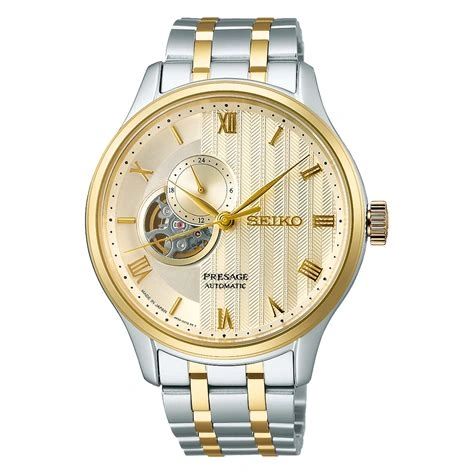 Elegant two-tone wristwatch with gold and silver accents and an open-heart dial.