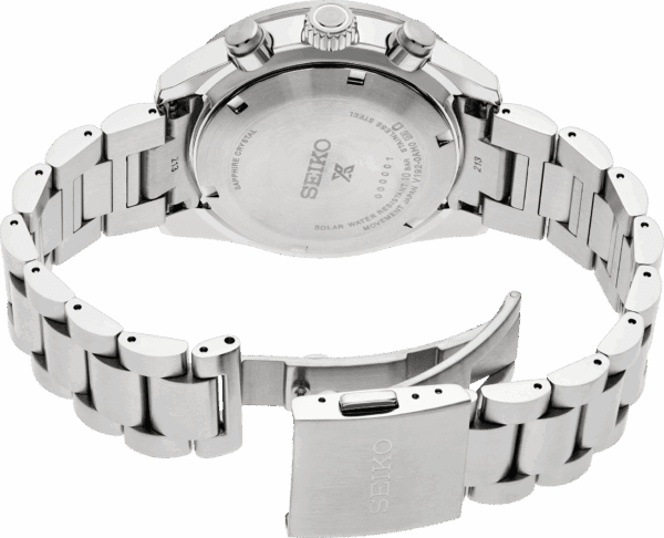 Close-up of a silver wristwatch showing its clasp and back case.