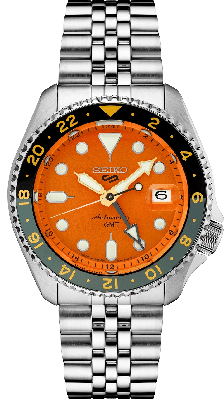 Seiko automatic GMT watch with bright orange dial and stainless steel bracelet.