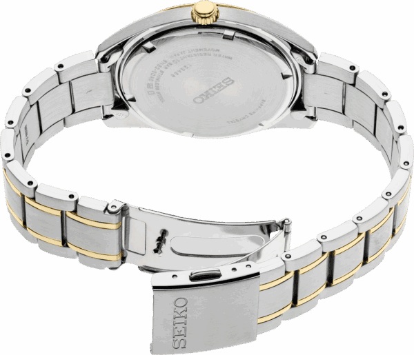 Close-up of a silver and gold-toned wristwatch bracelet with clasp open.