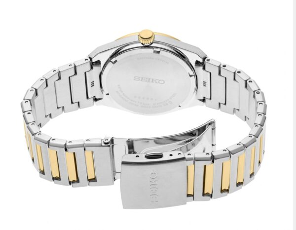 Two-tone metal wristwatch with a silver and gold bracelet.