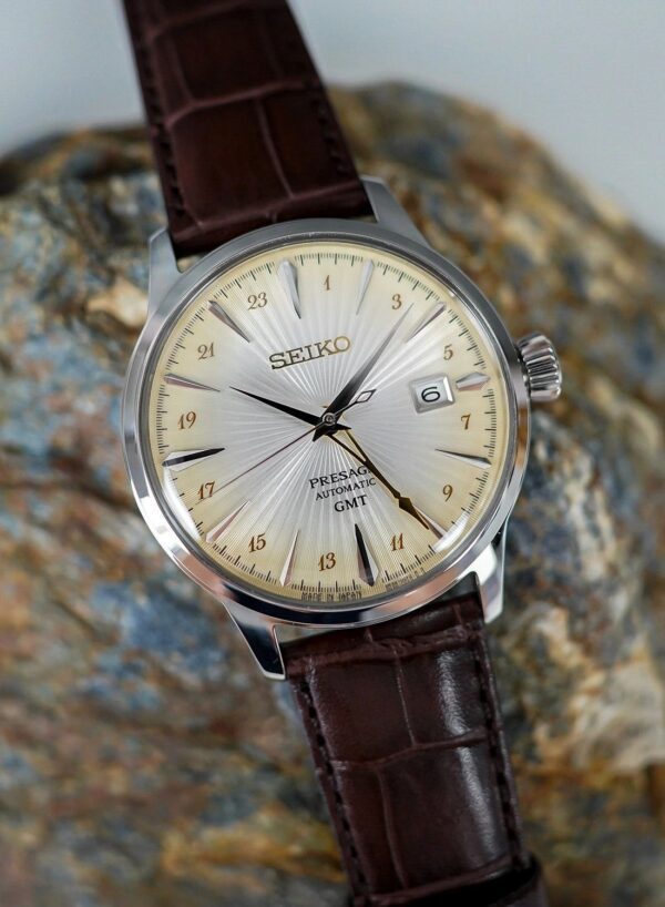 Close-up of a classic Seiko wristwatch with a brown leather strap.