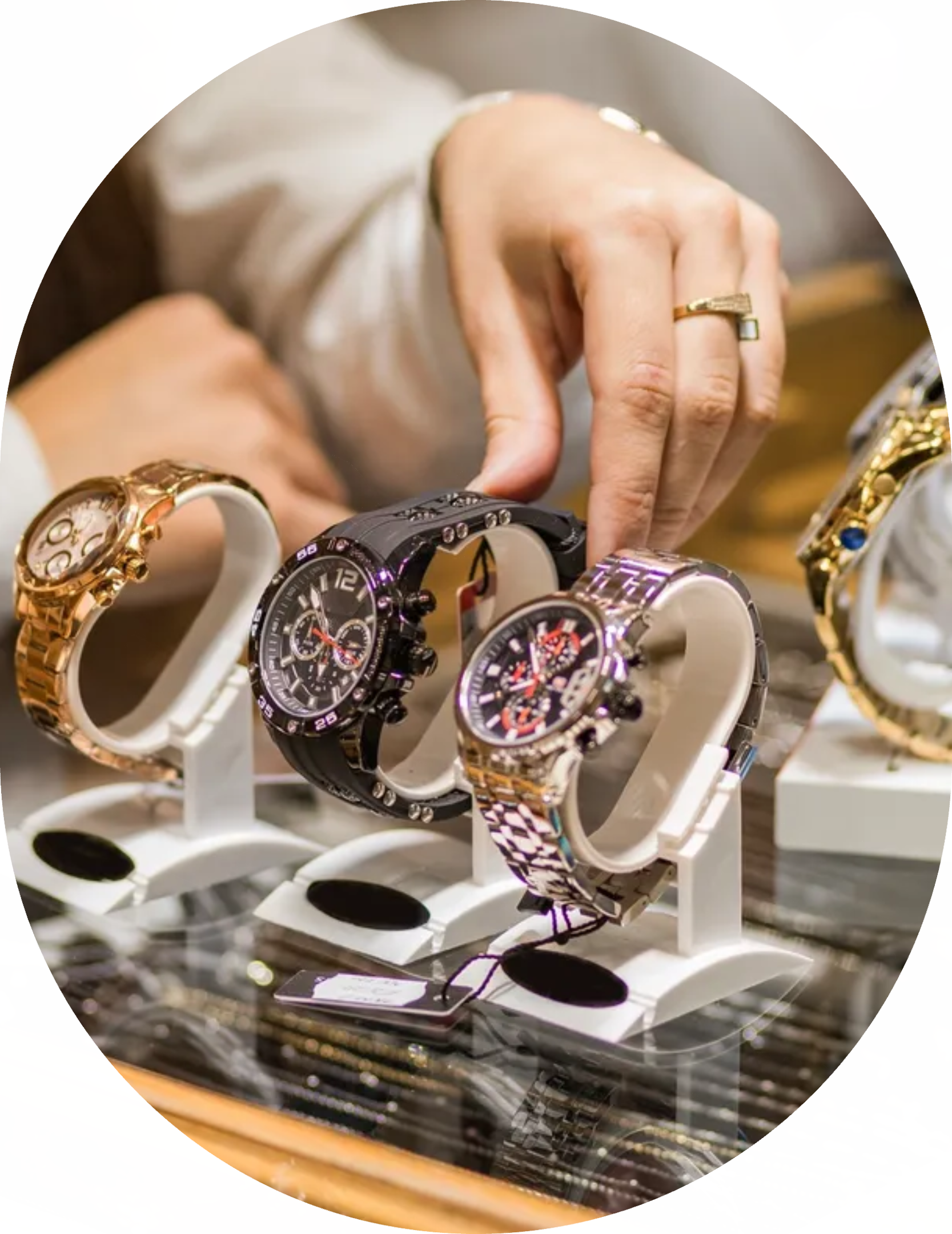 image A hand selecting a luxury watch displayed on a stand.