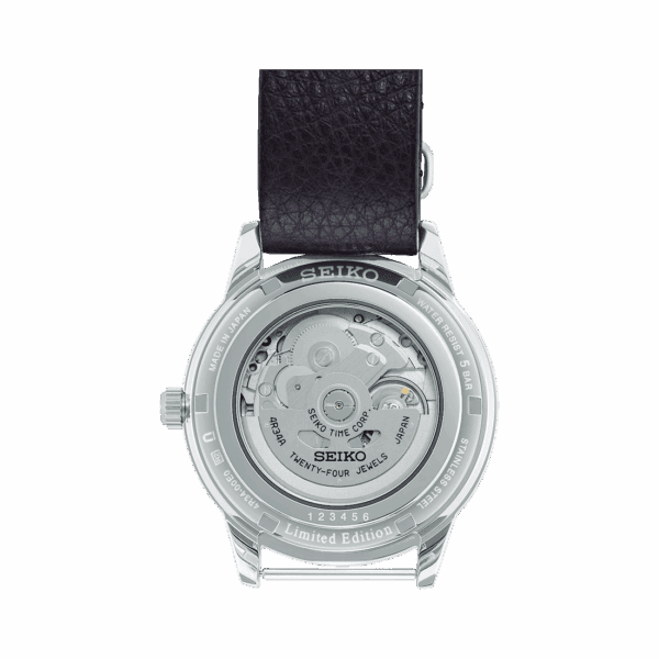 Back view of a wristwatch showing its mechanical movement through a transparent case back.