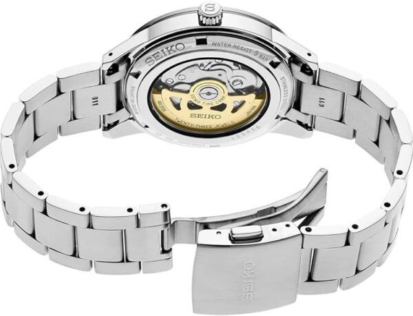 Luxury automatic wristwatch with visible movement and metal bracelet.