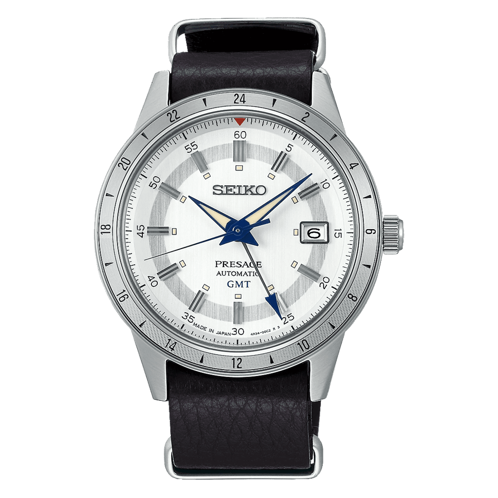 Silver Seiko wristwatch with white dial and black leather strap.