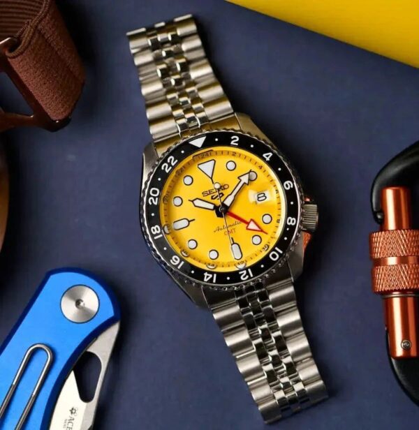 Stainless steel dive watch with bright yellow dial and rotating bezel.
